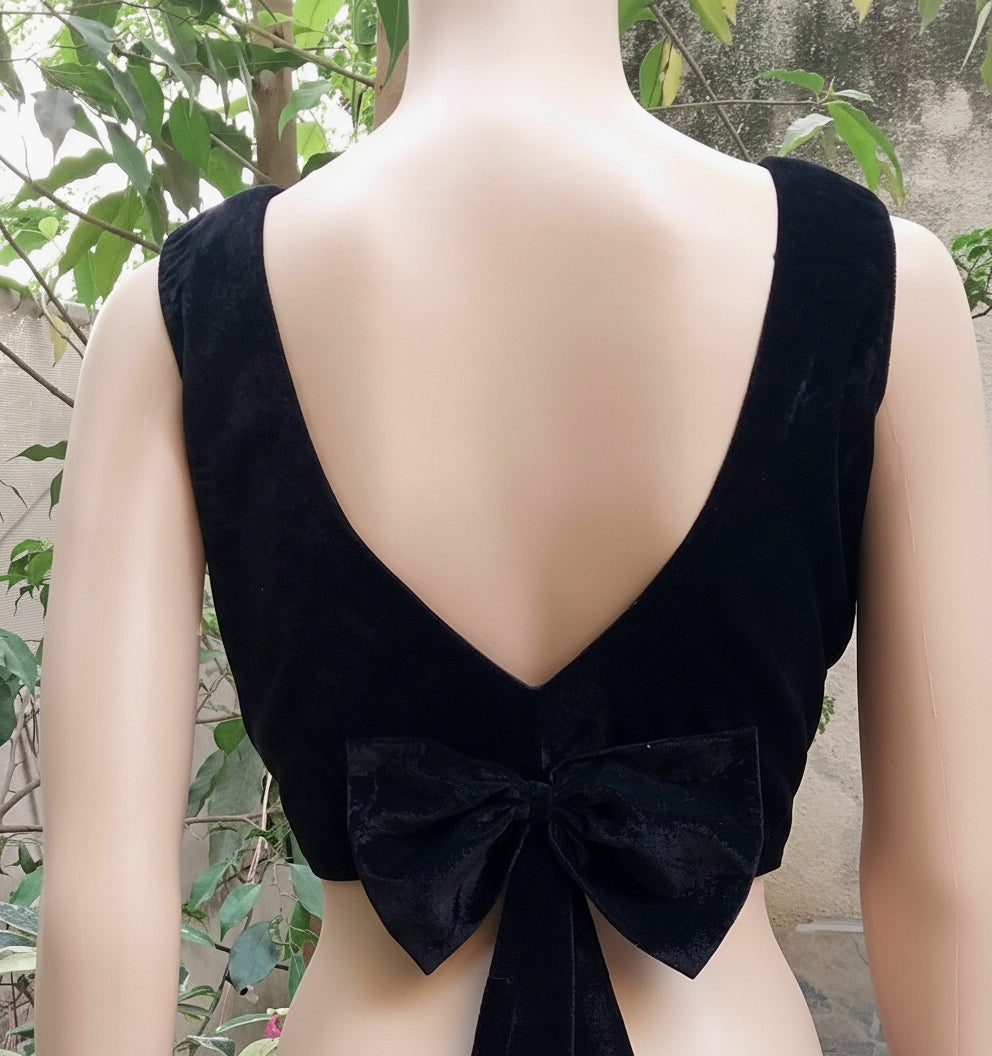 Black sleeveless top with a bow detail
