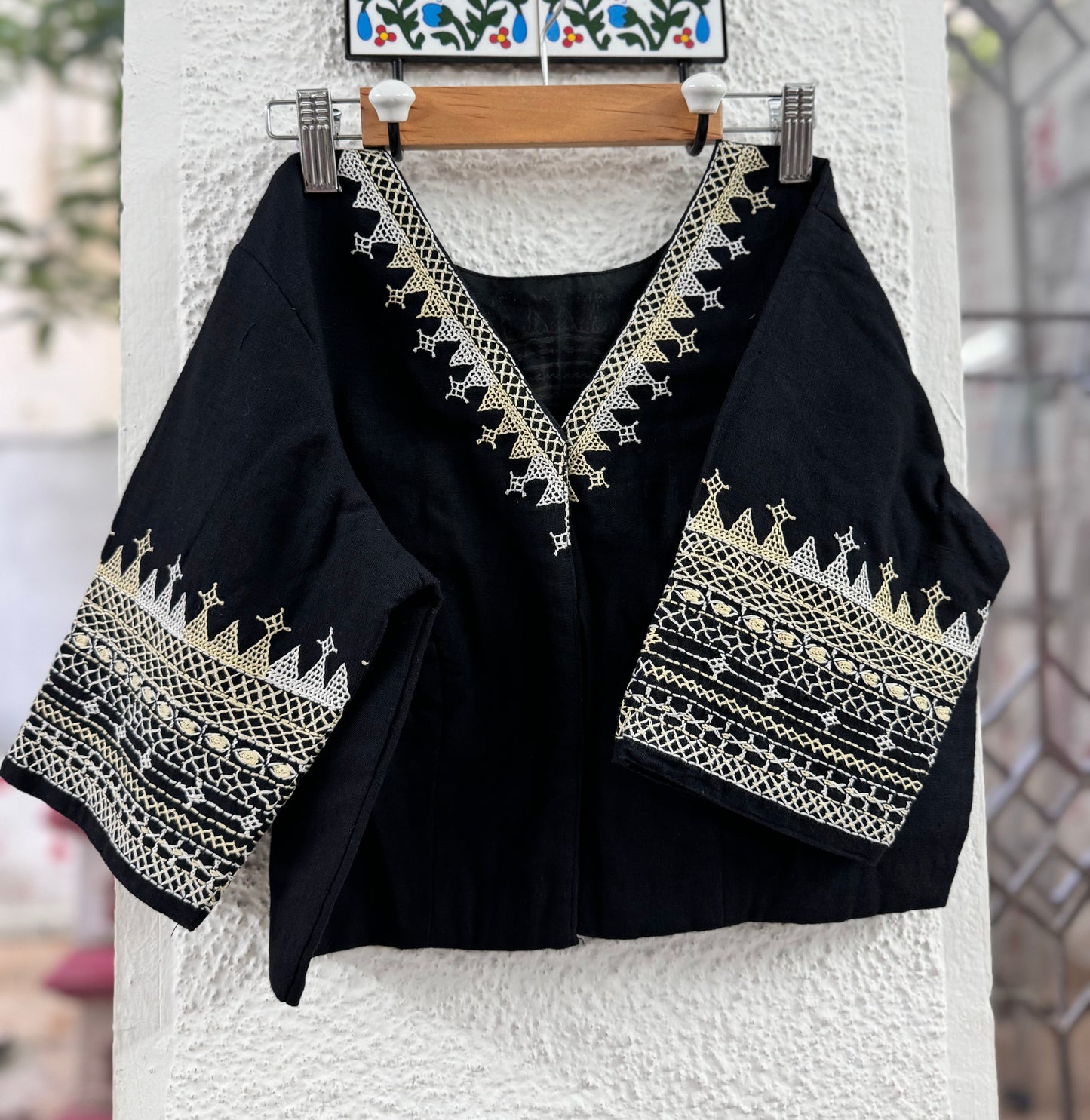 A black embroidered blouse with cream accents