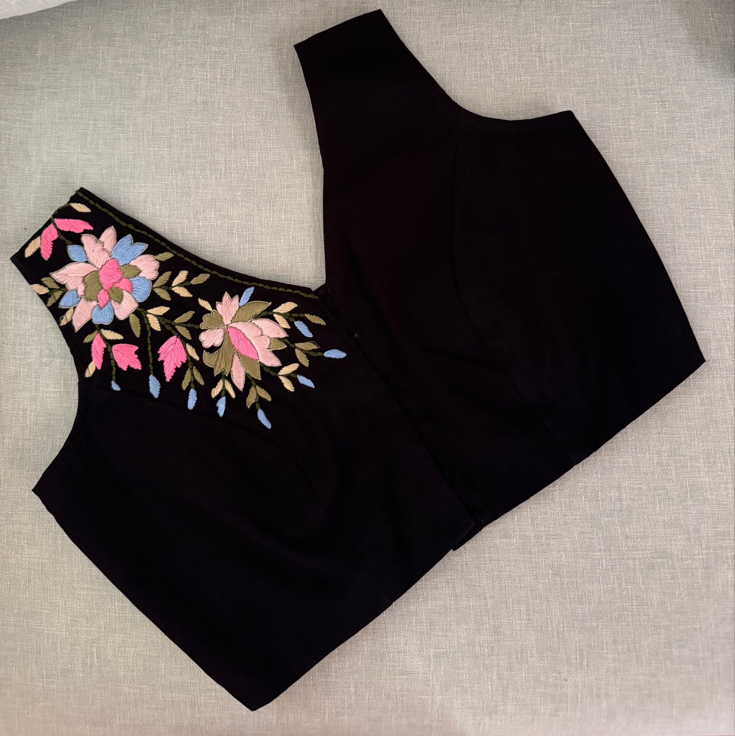 Black sleeveless blouse with floral embroidery
