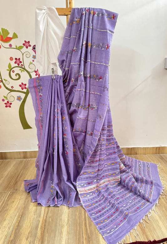 Purple saree with patterns on a wooden floor
