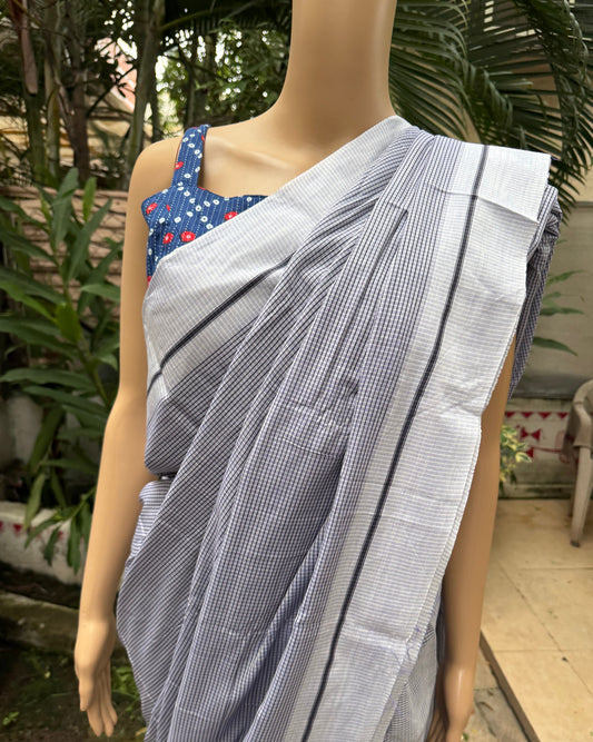 Person wearing a blue and white striped saree